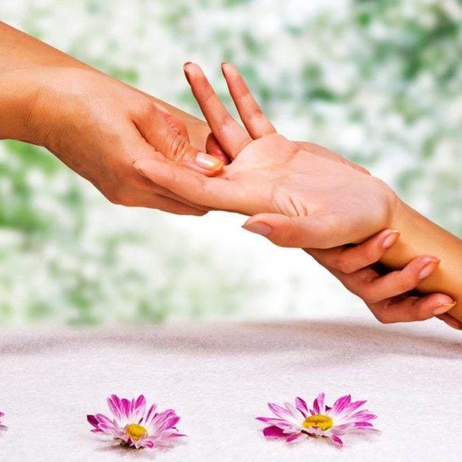 Hands massage in the spa salon in the garden
